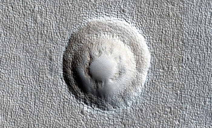 terraced ridges of large meteor strikes seen on Mars, such as this impact crater on the&nbsp;Arcadia Planitia.