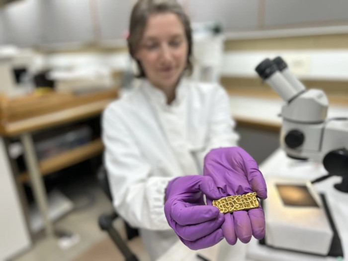 Researcher and conservator Hege Hollund at the Museum of Archaeology, University of Stavanger, presents the gold sword scabbard fitting