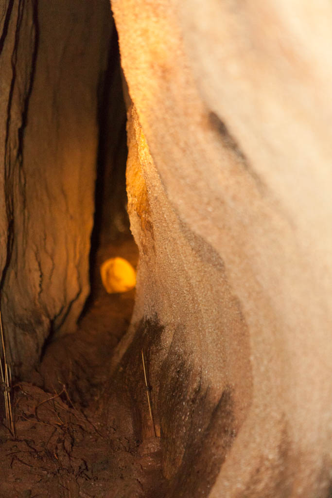 Gary squizing through small tunnel - Tayos Caves