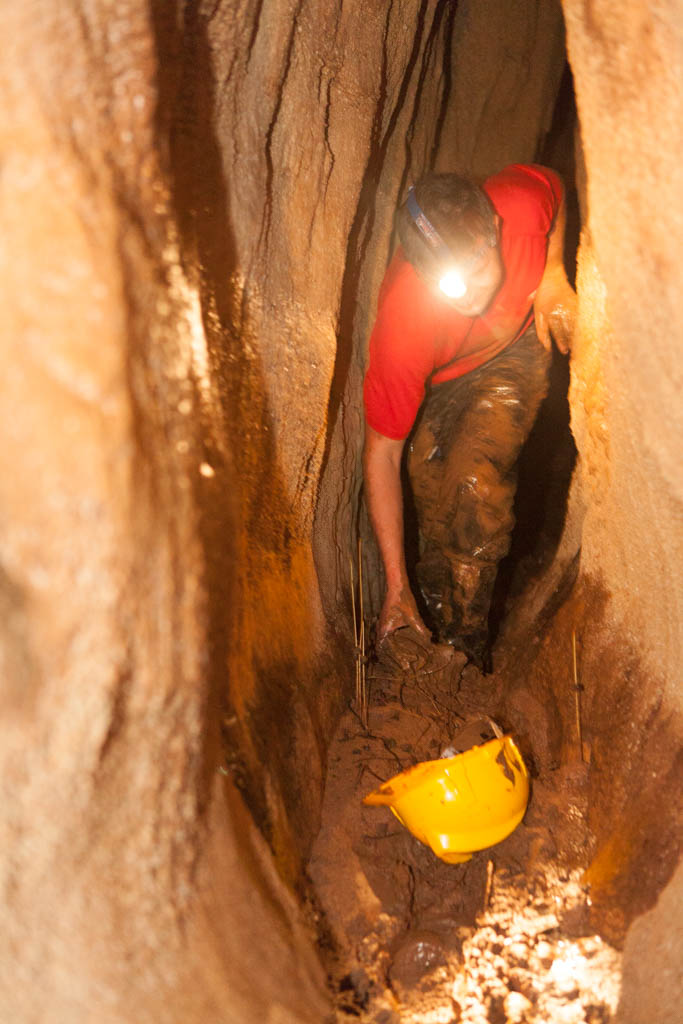 Gary squizing through small tunnel - Tayos Caves